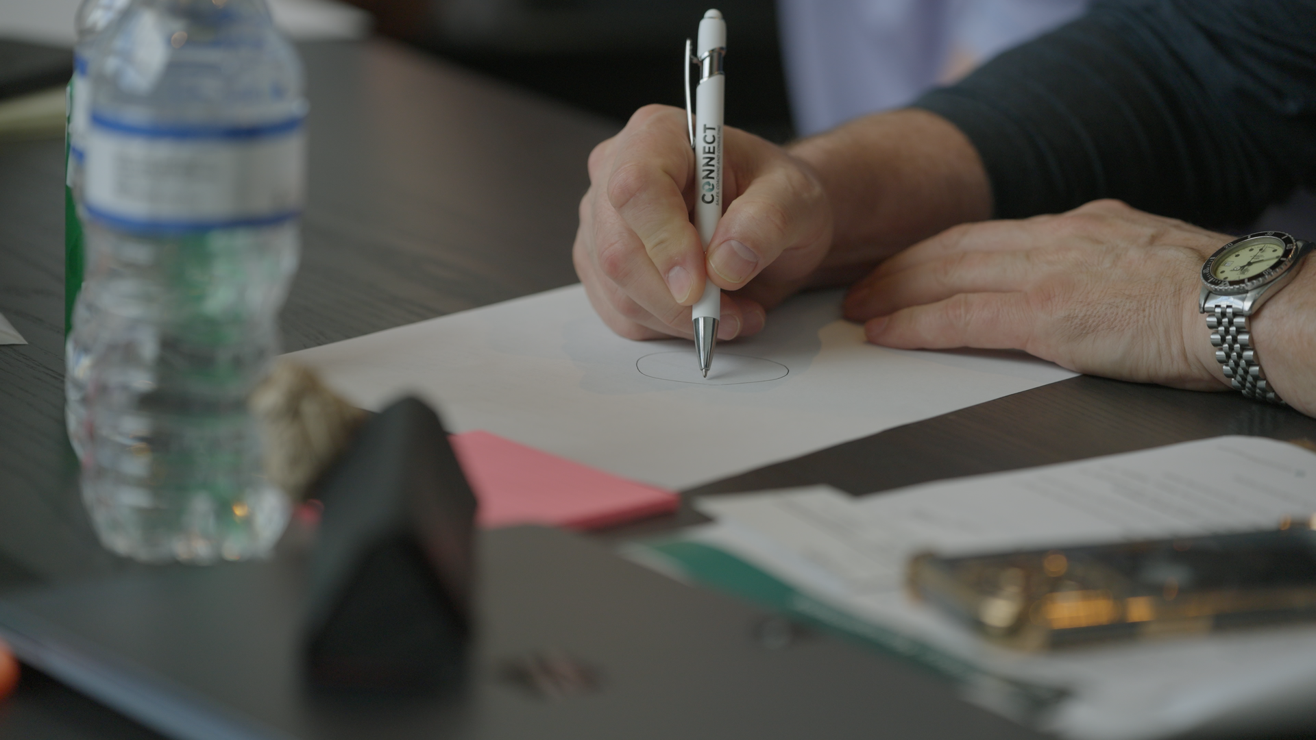 Individual writing with a pen image